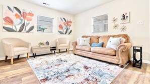A living room with a beige sofa, two armchairs, a coffee table, and a patterned rug. - Private Birmingham Retreat Near Red Mountain Park!

 (Birmingham)