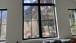 A room with a large window offering a view of a mountainous landscape. - New Luxury Home in the Heart of Ouray, Walk Main St, Breathtaking Views, AC (Ouray)