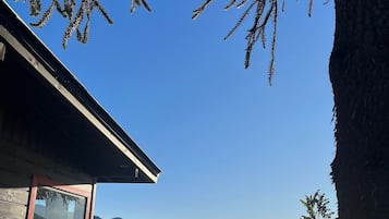 Escape to a serene mountain retreat with breathtaking views of lush green fields and distant mountains.