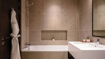 Separate tub and shower, designer toiletries, hair dryer, bathrobes
