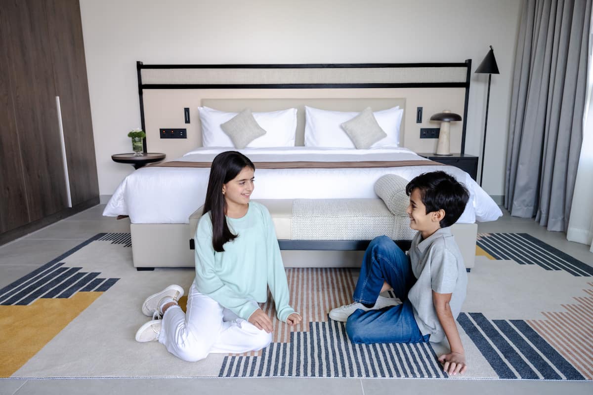 A bedroom with a large bed, bedside tables, and a nightstand.