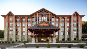 A multi-story hotel with a prominent entrance, large windows, and stone pillars.