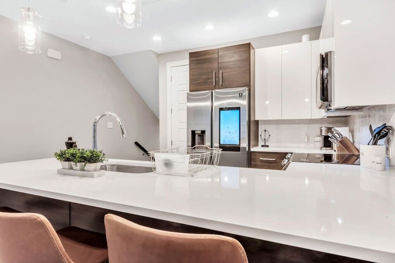 A modern kitchen with a large island, stainless steel appliances, and a sleek design.