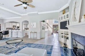 A spacious living area with a fireplace, a dining area, and a kitchen. - Jacuzzi & Pool 3,500 SF Fashion Gallery Home (Plano)