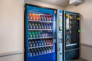 A vending machine with a selection of beverages and snacks. - Woodspring Suites Downers Grove - Chicago (Downers Grove)