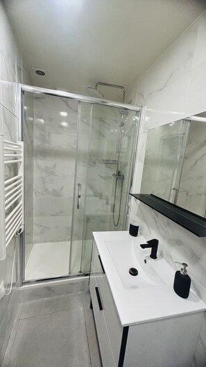 Chuveiro, secador de cabelo, toalhas de banho, sabonete