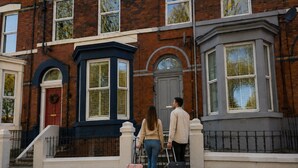 A townhouse with a red door, a bay window, and a white picket fence. - Botanic Apartment Central-Parking-sleep3 (Liverpool)
