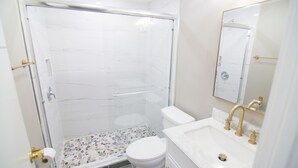 A bathroom with a shower, toilet, and sink. - The Capitol Inn - Orlando Room - 2 Twin beds (Tallahassee)
