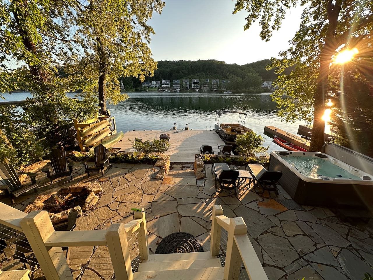 Une terrasse au bord du lac, avec des sièges d’extérieur, un jacuzzi et une vue sur le lac.