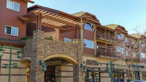A multi-story hotel with a stone facade, balconies, and a covered entrance. - Stylish, fully equipped 2-bed / 2-bath condo in Riverstone Village (Coeur d'Alene)