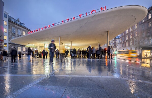 A modern building with a curved roof and the word "HOTEL" in red letters.
