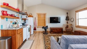 Un espacio habitable compacto con cocina, comedor y zona de estar.