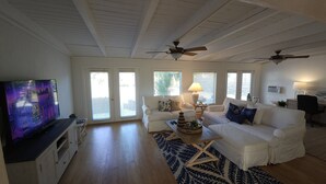 A spacious living room with a television, two sofas, a coffee table, and ceiling fans. - Casey Key/Nokomis Florida home, minutes to the beach (Nokomis)