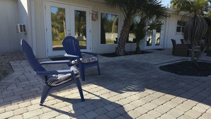 Two blue chairs with striped cushions on a paved patio. - Casey Key/Nokomis Florida home, minutes to the beach (Nokomis)