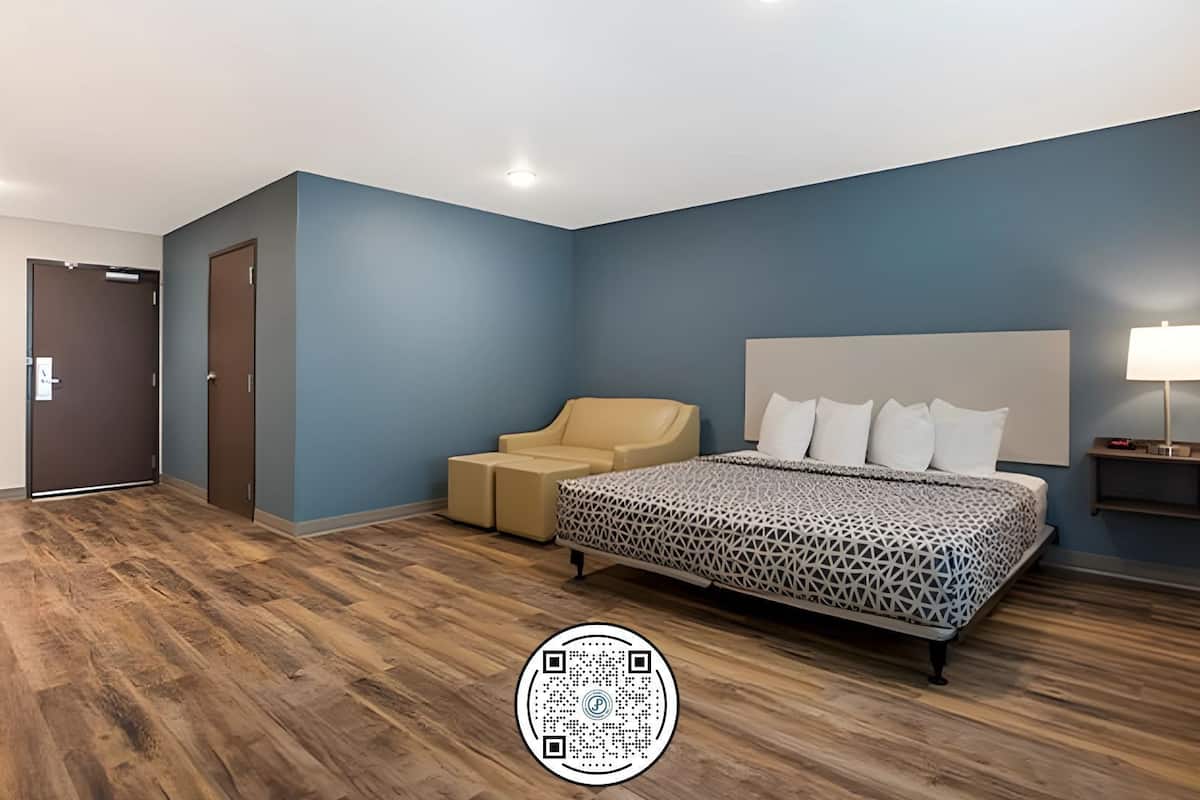 Une chambre à coucher moderne avec un lit, un canapé et une table de chevet.