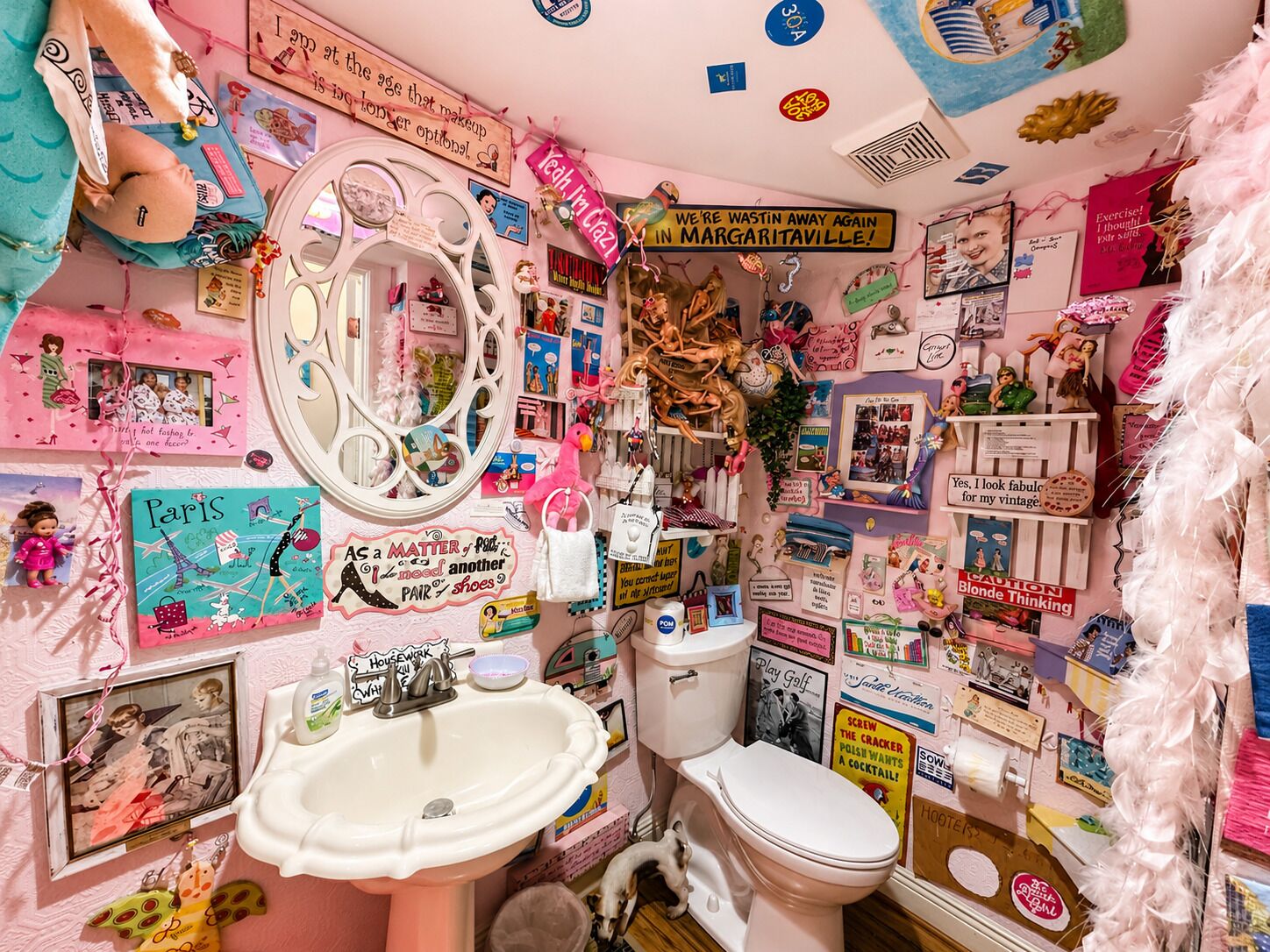 A bathroom with a sink, toilet, and mirror.