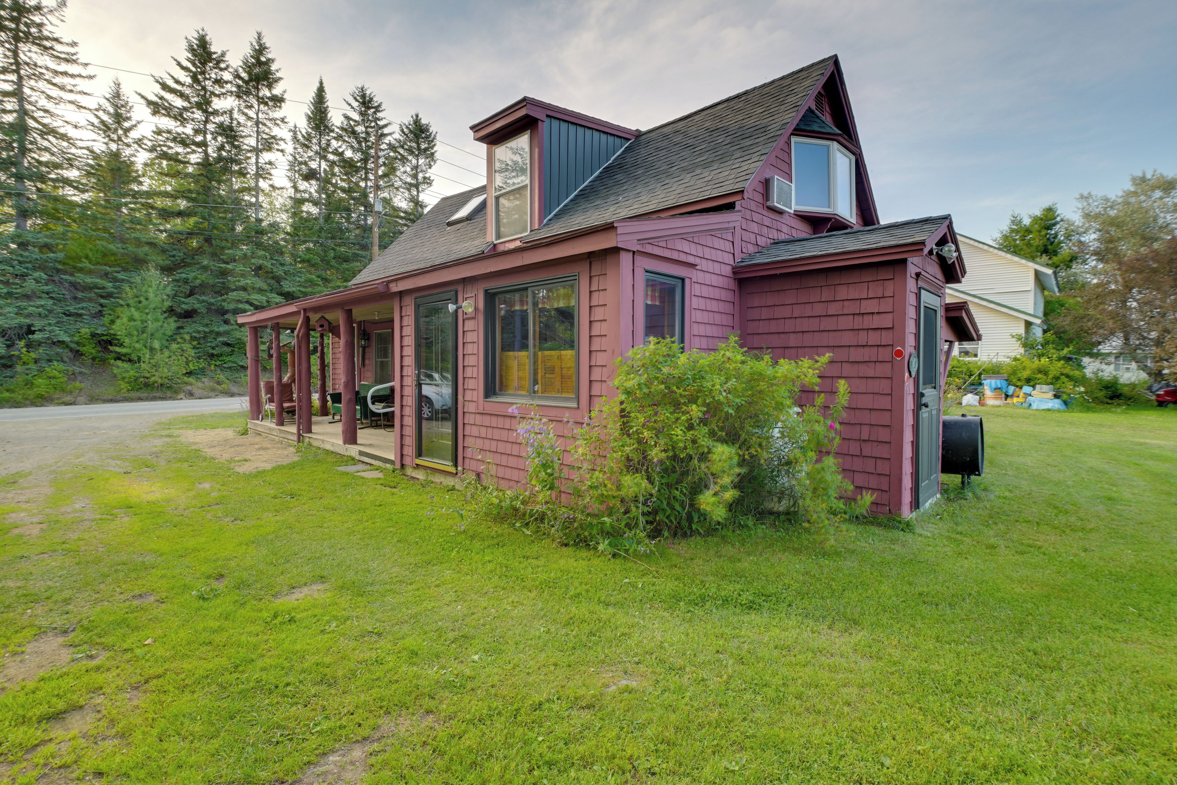 A two-story house with a covered porch and a garage.
