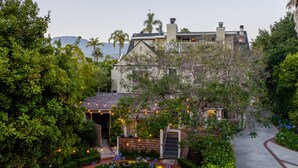 A house with a garden, a pathway, and a view of mountains. - The De La Vina Inn (Santa Barbara)
