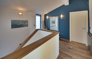Staircase leads to an upper level with a door and window.