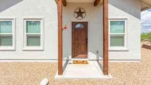 A building with a wooden porch, a star-shaped decoration above the door, and a number '1166' on the wall. - Experience the Wild West in Style: Unforgettable Getaway in Tombstone, Arizona!! (Tombstone)