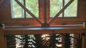 A room with a high ceiling and large windows, allowing natural light to enter. - Luxury Log Cabin adjoins GSMNP . Magnificent Views , Nature Lovers Paradise ! (Townsend)