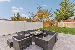 A patio with a square table and four chairs.