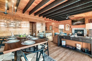 A wooden interior with a dining area, kitchen, and living space. - 5 Starr Views! Hot Tub Games. Sleeps 20 5 BR 4.5 baths. Close to Dollywood (Sevierville)