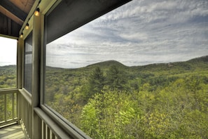 Enjoy a panoramic view of the surrounding hills from this balcony.