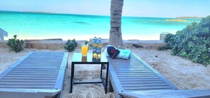 Private beach, white sand, sun loungers, beach umbrellas