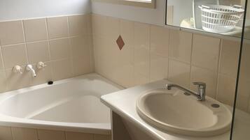 Een douche, handdoeken, zeep, toiletpapier