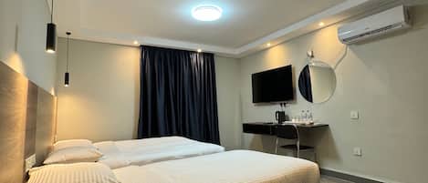 Premium bedding, desk, laptop workspace, soundproofing