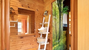 A wooden interior with a wooden ladder shelf, a bench, and a forest mural. - Holiday Home 'Hüssli Numero 1' with Private Terrace, Shared Garden and Wi-Fi (Hayingen)