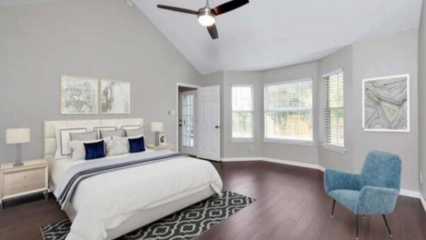 A bedroom with a bed, a ceiling fan, a nightstand, a chair, and a window. - Enjoy a nice home with a beautiful garden.   (Fort worth)