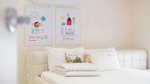 A bedroom with a white bed, a teddy bear, and two wall art pieces with motivational quotes. - Gyeongju Jullietapoolvilla&kidspension (Gyeongju)