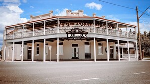 A two-story building with a balcony and a sign that reads "HOLBROOK HOTEL". - Holbrook Hotel (Holbrook)