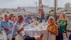 A group of people seated at a table with a view of the cityscape. - Holbrook Hotel (Holbrook)
