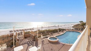 A pool area with a view of the beach and ocean. - Seychelles 205 (Panama City Beach)
