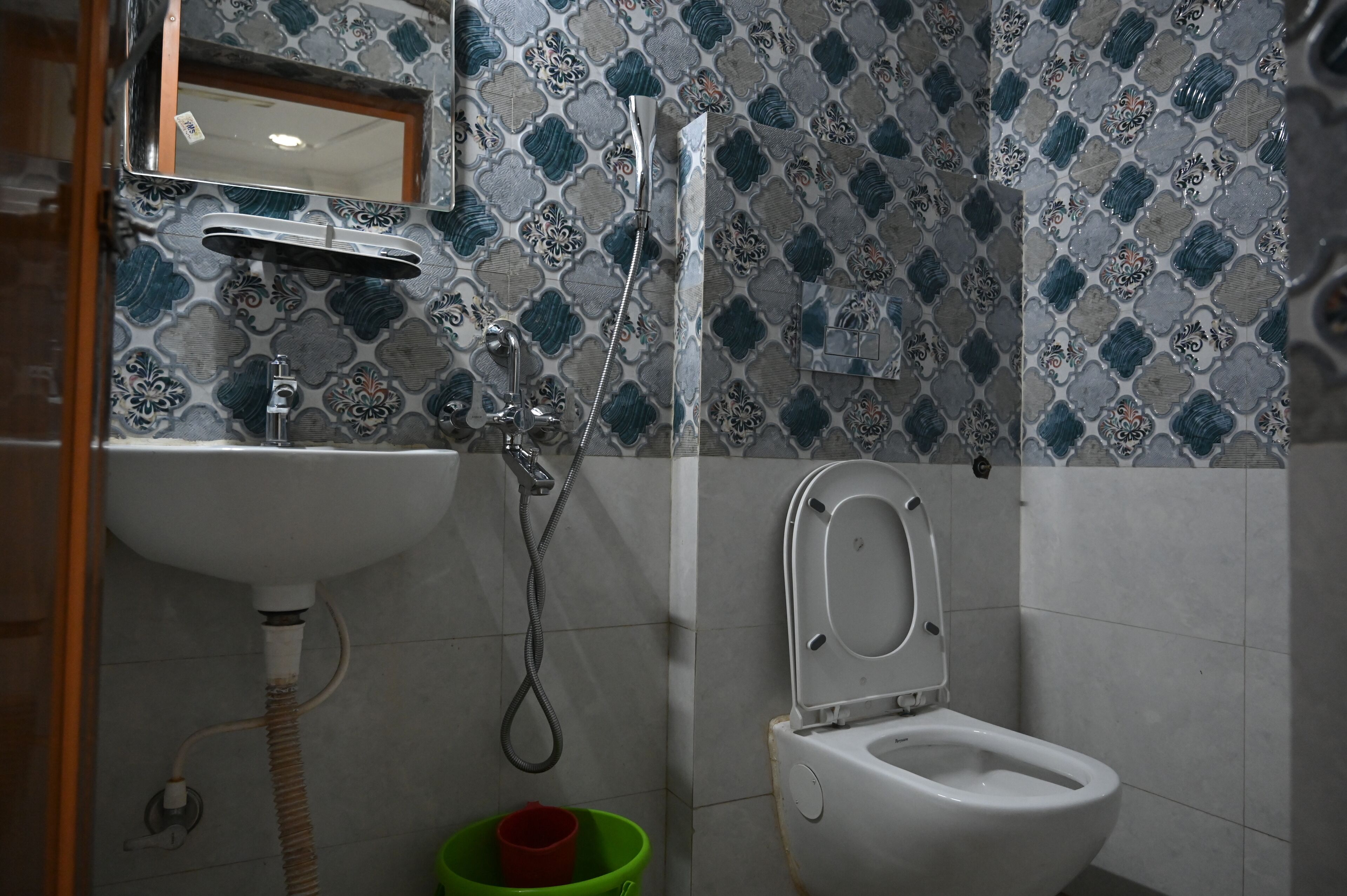A bathroom with a sink, a toilet, and a shower.