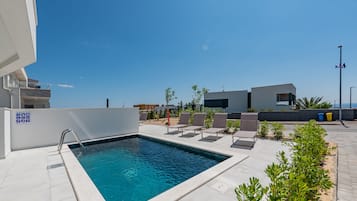 Seasonal outdoor pool, open 9:00 AM to 9:00 PM, pool loungers