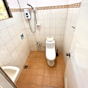 Bathroom features a shower unit, toilet, and decorative border.