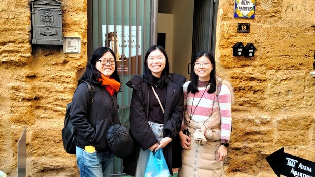 Three people standing in front of a building with a sign indicating 'Atena Apartments'. - Atena apartments 1 Agrigento center: your retreat in Agrigento (Agrigento)