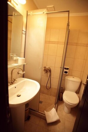 A bathroom with a sink, toilet, and shower. - Spon Boutique Hotel (Nafpaktos)