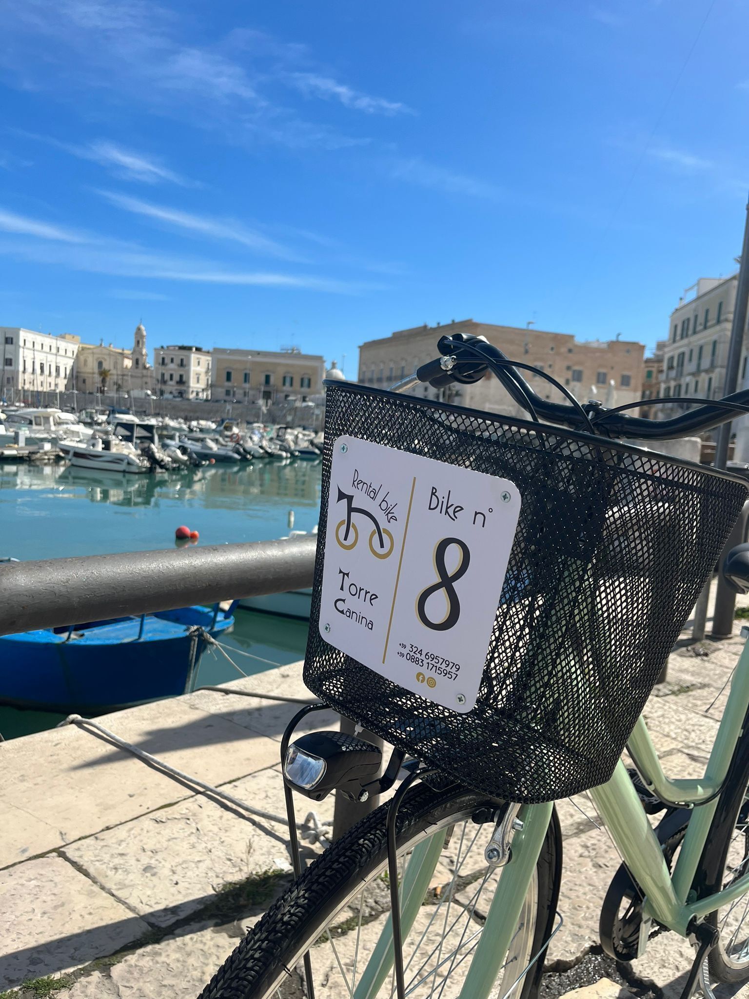 A rental bike with a sign indicating it is for use at Torre Canina.
