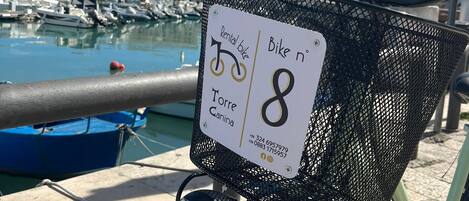 A rental bike with a sign indicating it is for use at Torre Canina.