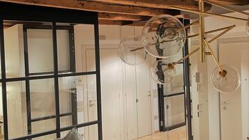 A modern interior with a wooden ceiling, a glass door, and a mirrored wall.