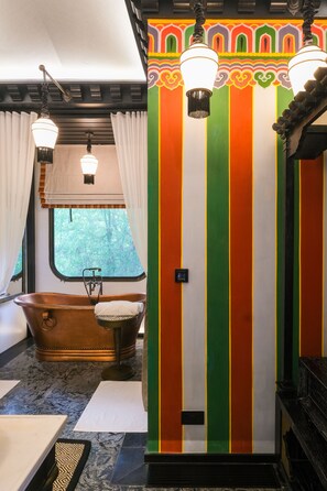 A room with a bathtub, striped walls, and hanging light fixtures. - Pemako Punakha (Punakha)
