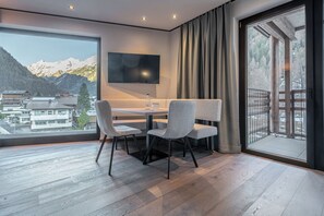 Family Suite, Mountain View | Living area | 70-cm flat-screen TV with cable channels - Edelweiss echt.charmant. (Soelden)