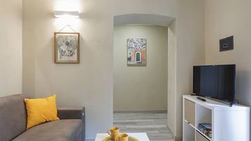 Standard Apartment | Living area | 35-inch flat-screen TV with digital channels