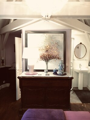 A room with a large window, a wooden dresser, a mirror, and a sink. - Manoir du Clap (La Cerlangue)