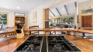 A spacious kitchen with a large island, built-in gas stove, and wooden cabinetry. - Mountain Views from Private Hot Tub and Balcony and Large Windows (Keystone)